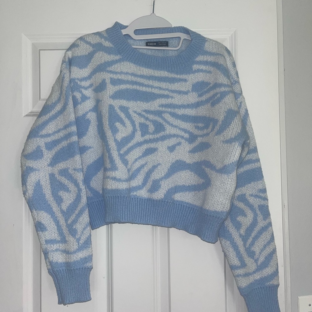 Blue and white patterned sweater.